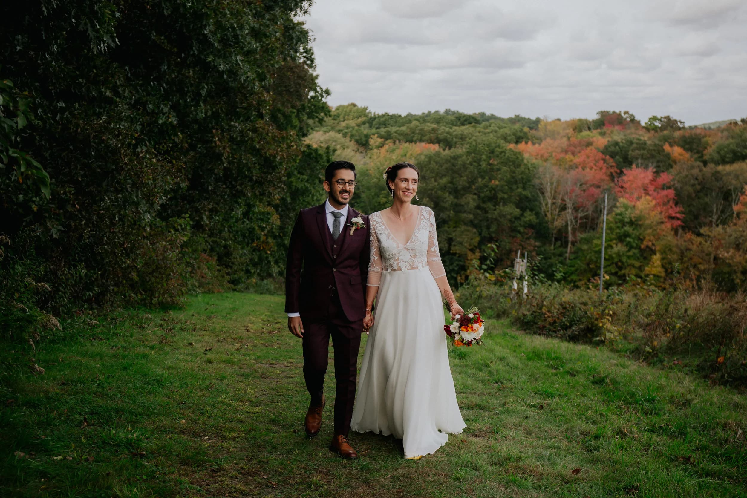 Bride and groom standing together in a garden.