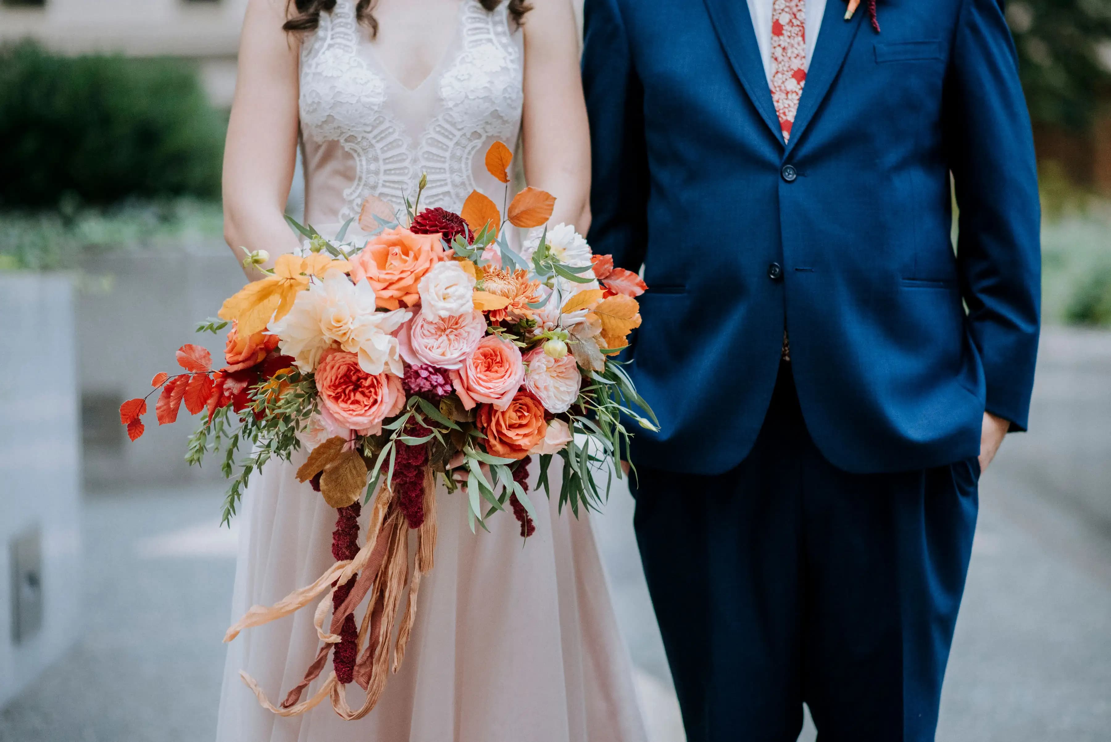 Close view of a colorful bouquet between the couple.