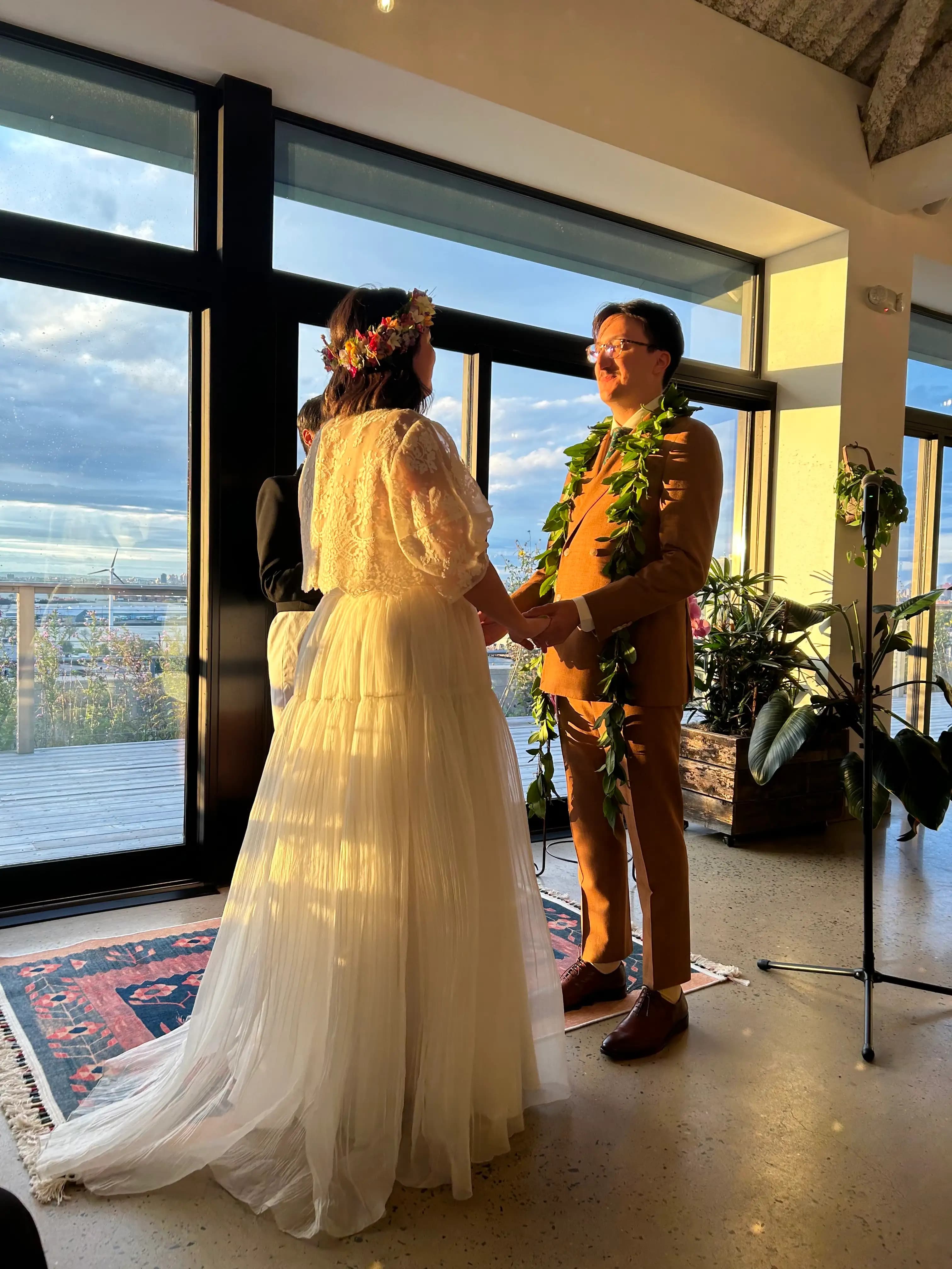Bride and groom holding hands during a ceremony.