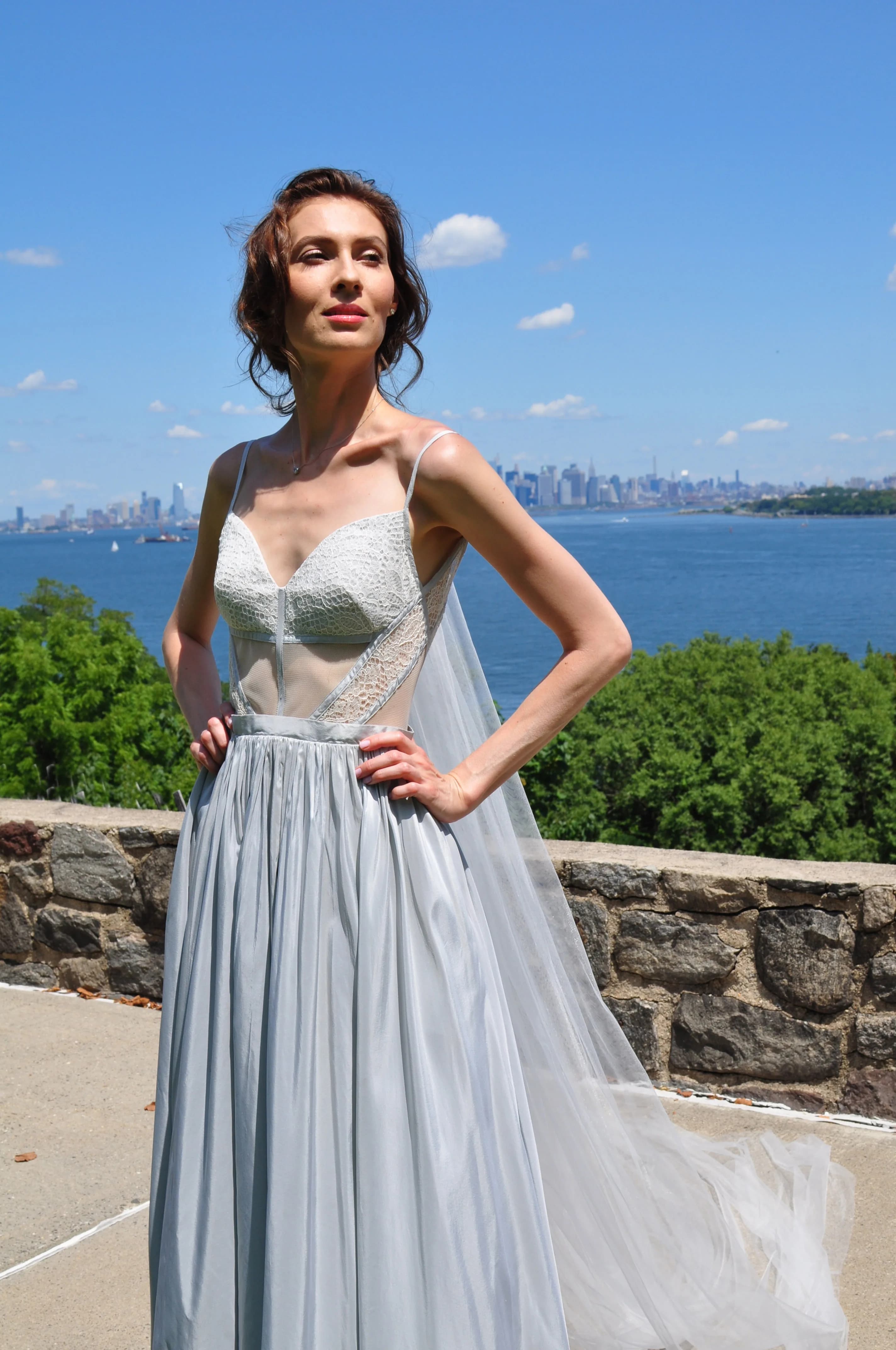 Close view of a bride in a silver lace bodice.