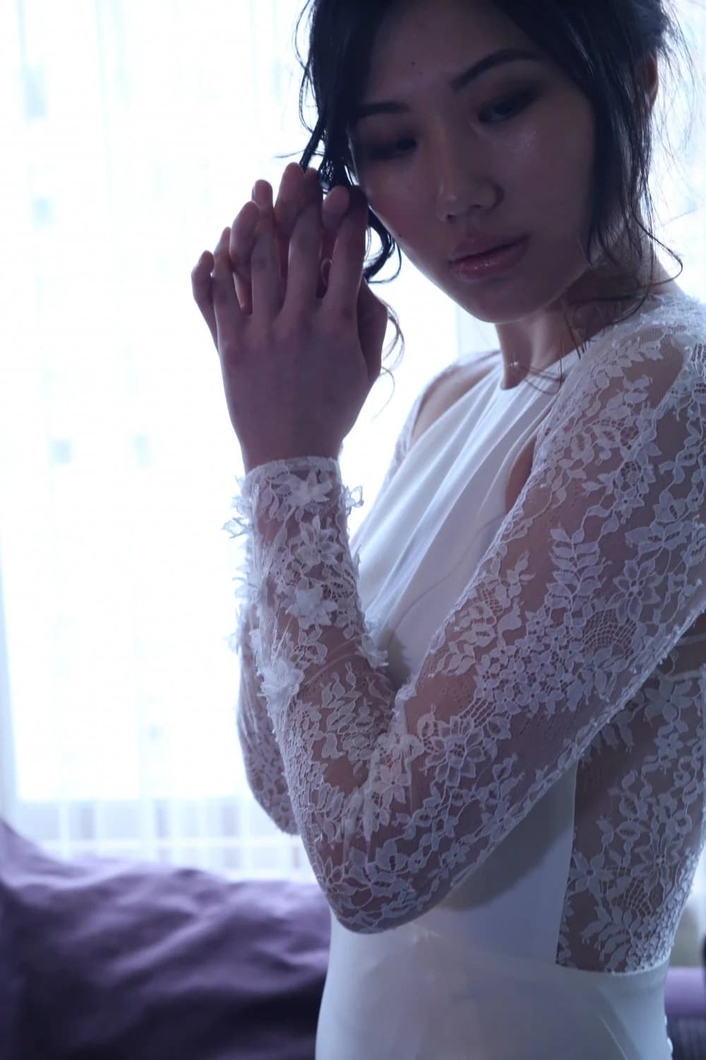 Close view of a bride wearing a lace bolero.