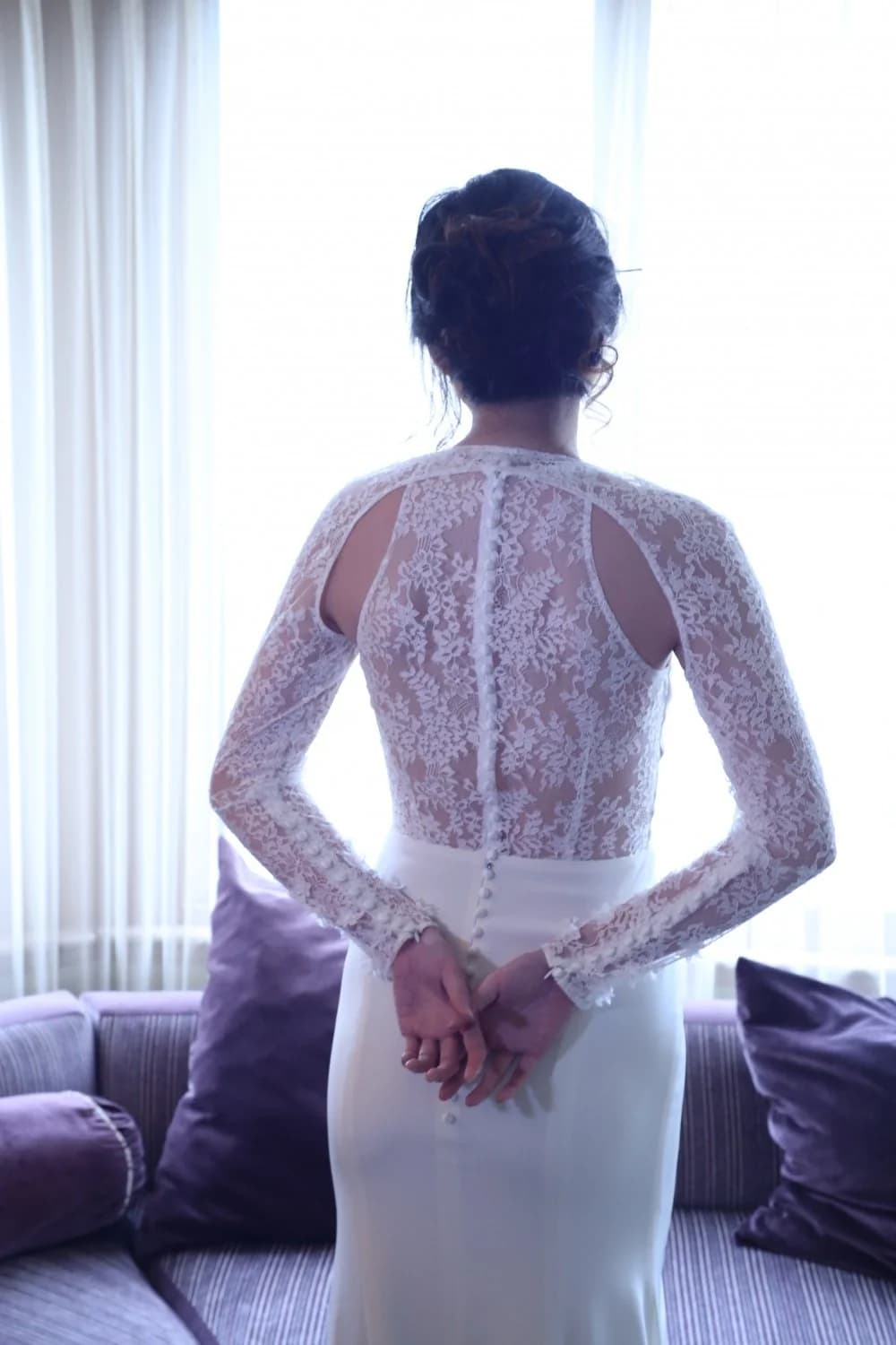 Bride showing a lace bolero back indoors.