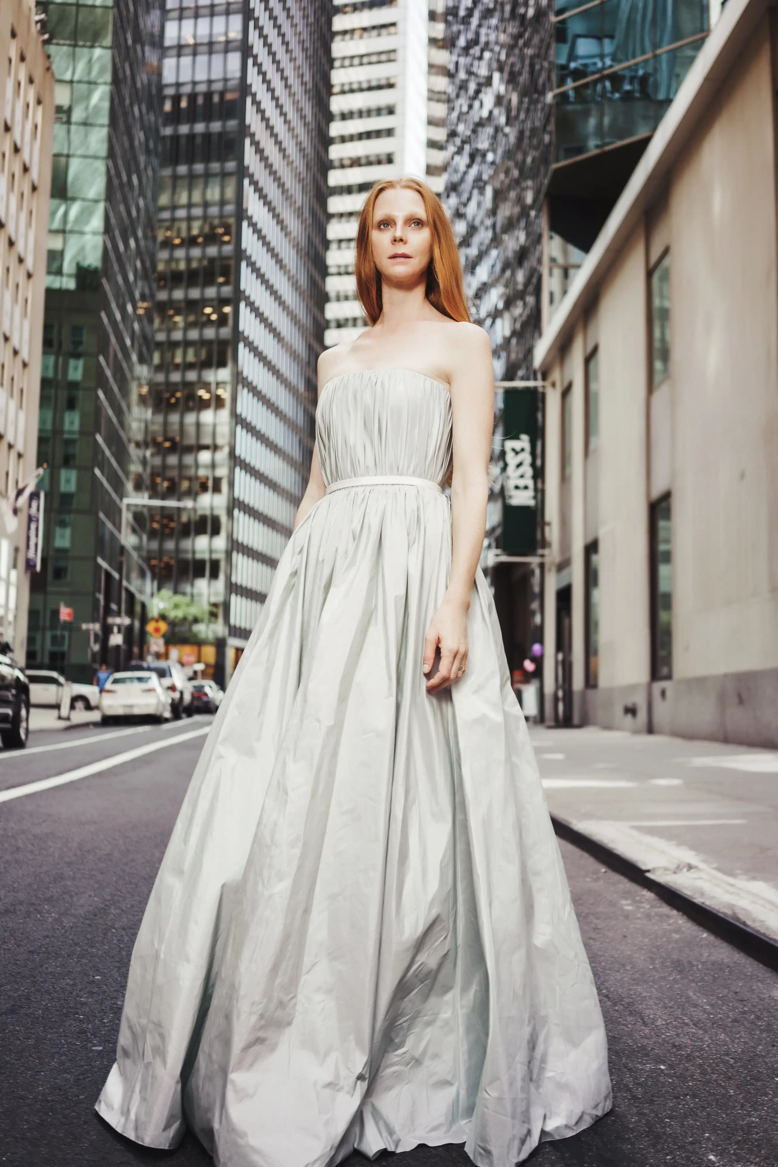 Bride in a pleated gown on a downtown street.
