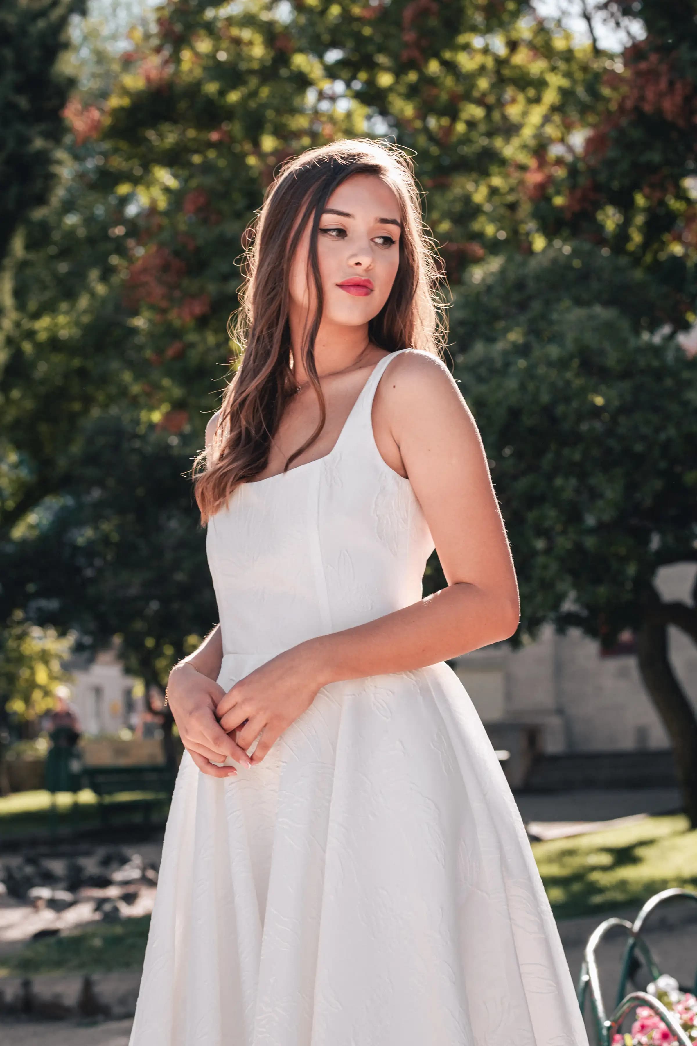 Close portrait of a bride in a garden at golden hour.